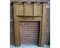 antique oak Arts and Crafts fire surround with carved details.